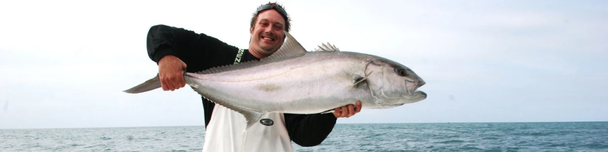 Close-up of Nick Honachefsky holding an amberjack fish