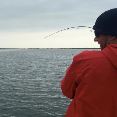 Josh Jorgensen fishing from the back of a boat