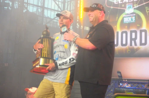An angler and presenter on stage at the Bassmaster Classic