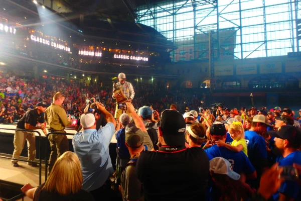 A winner standing in front of the crowd at the Bassmaster Classic