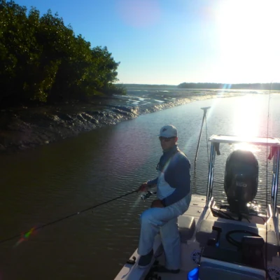 Captain Mike Venezia standing on a boat fishing in the canal water