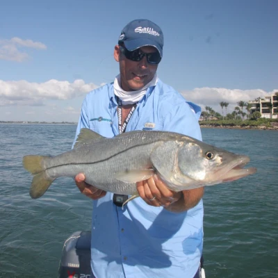 An angler holding a snook