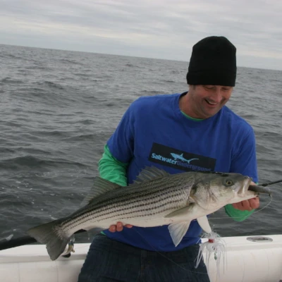 Nick Honachefsky holding a striper