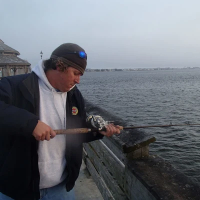 An angler fishing from a pier