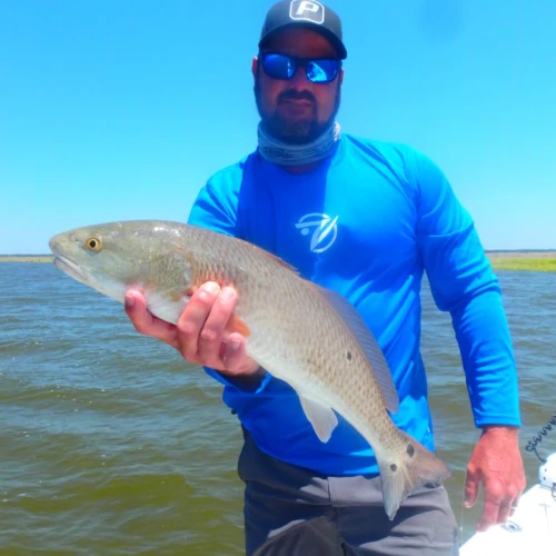 An angler holding a redfish
