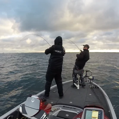 Two anglers fishing from a bass boat