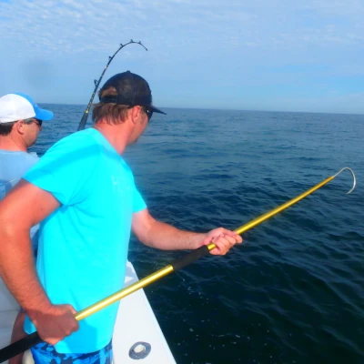 Two anglers fishing off the side of a boat