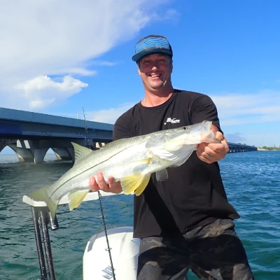 Nick Honachefsky holding a snook with the Islamorada Bridge in the background
