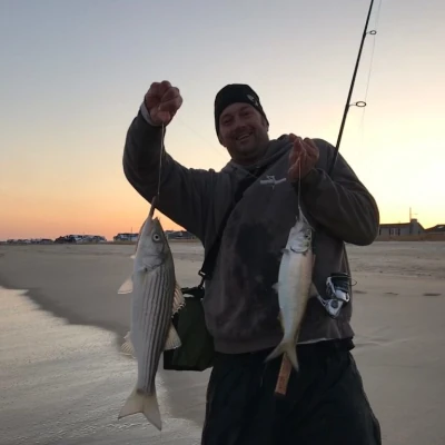 Nick Honachefsky holding up a hickory shad and another fish