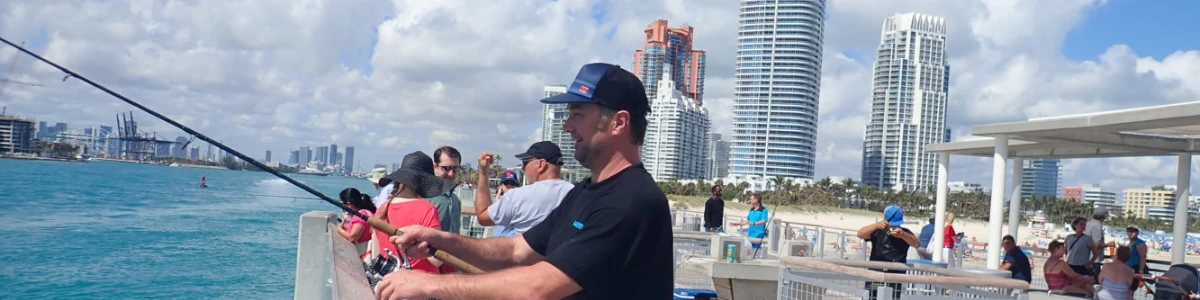 Close-up of Nick Honachefsky fishing from the Miami pier