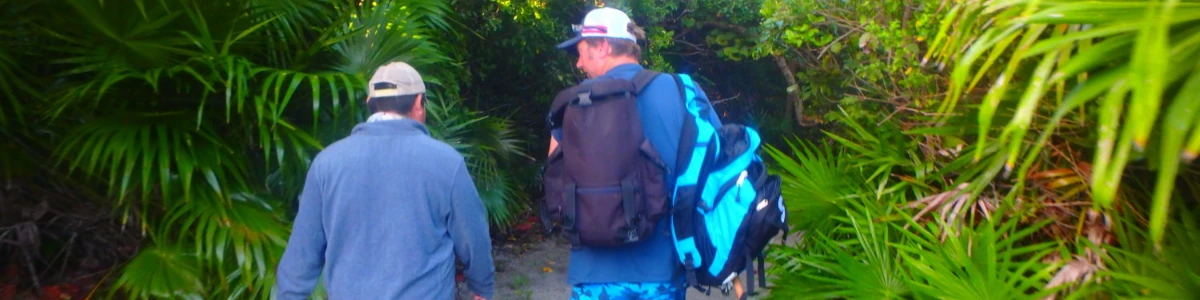 Close-up of a Nick Honachefsky and another man walking from the beach