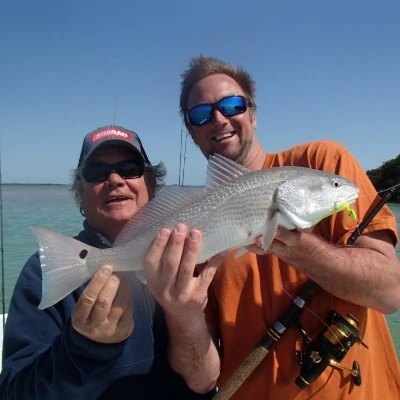 Nick Honachefsky holding a fish with another angler