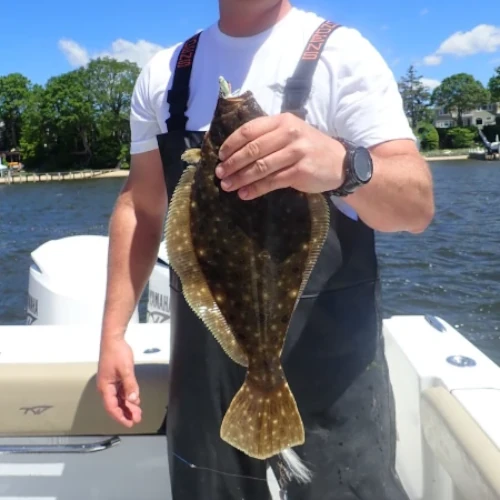 Nick Honachefsky holding a fluke fish