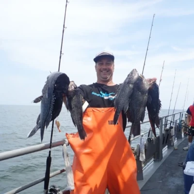 Nick Honachefsky holding a several sea bass
