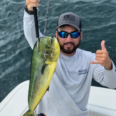 Several angler leaning over the side of a boat and fishing