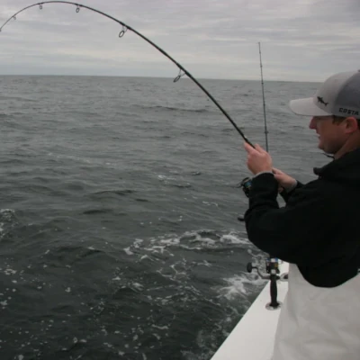 A man fishing off the side of a boat