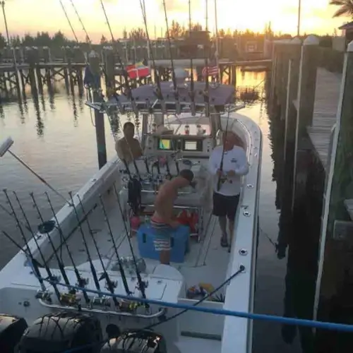 Cheapshot Sportfishing charter boat at the dock with three anglers