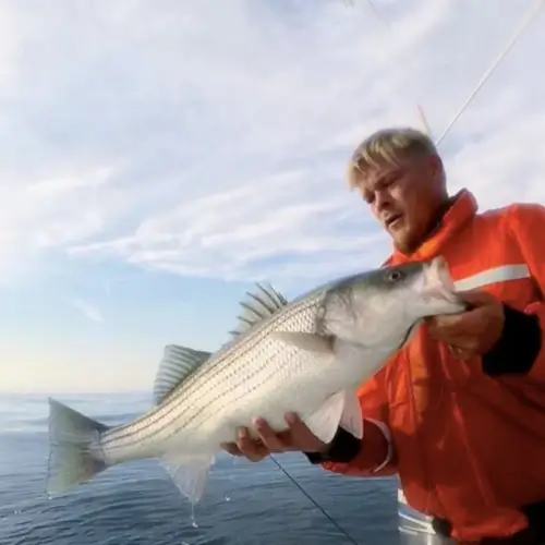 Dan Schafer holding a striper