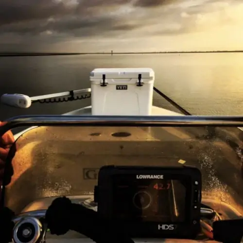 A boat with gear on the water in the evening